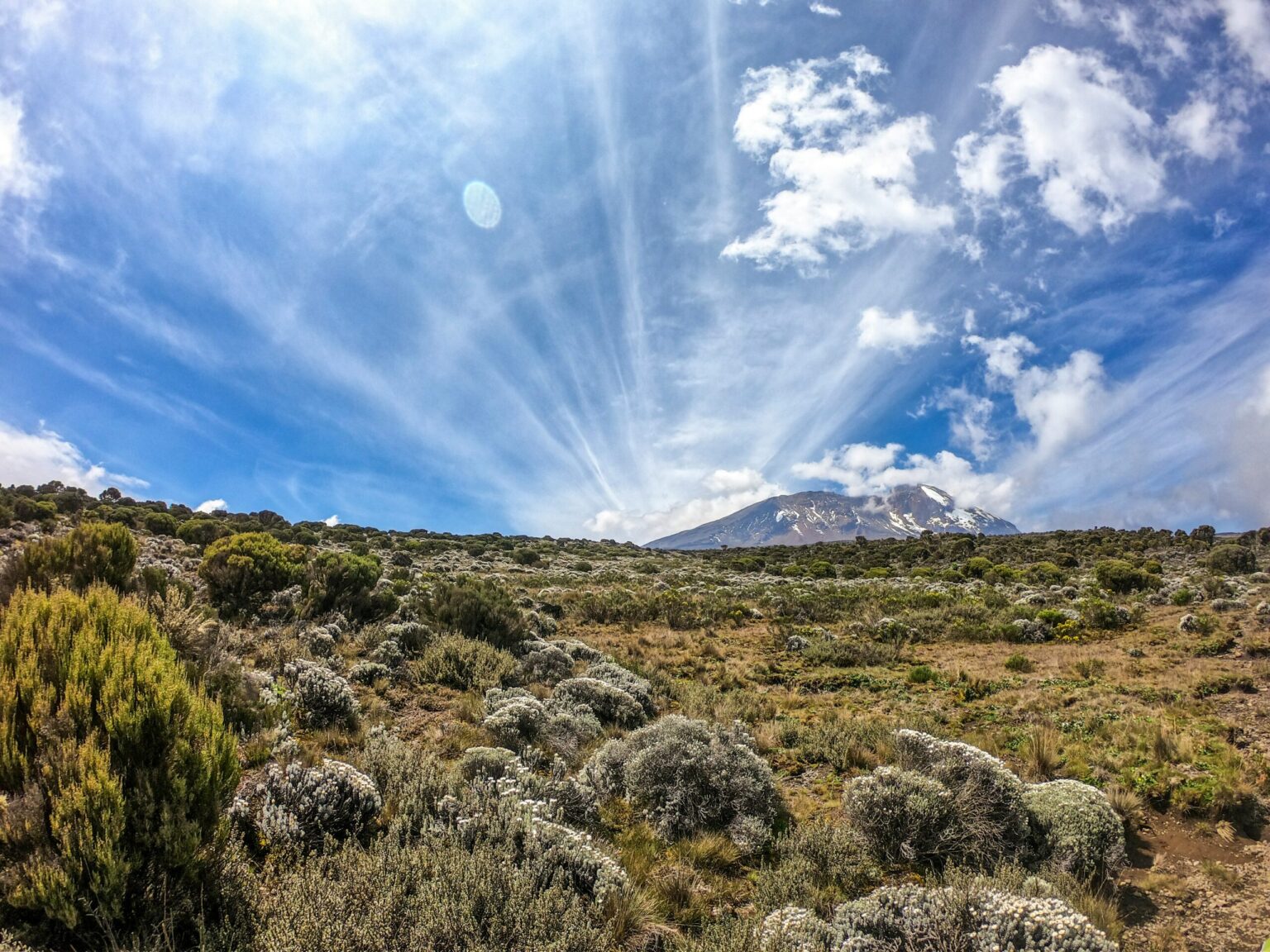 Sunbeams over the Kenyan bush and Mount Kilimanjaro