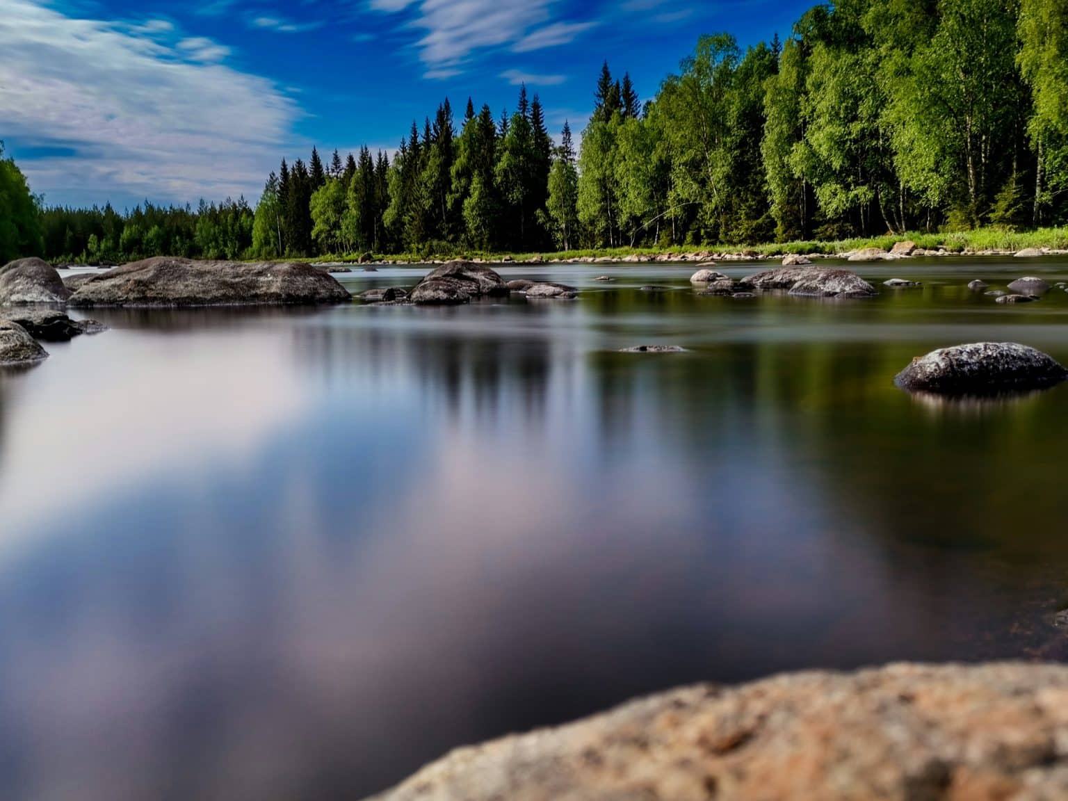 Calm lake bordered by forest, Sweden